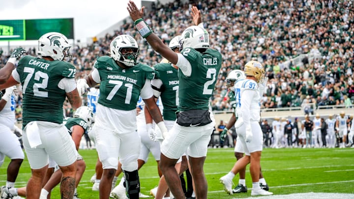 Michigan State's Aidan Chiles, center, celebrates his touchdown against UCLA during the first quarter on Saturday, Oct. 11, 2025, at Spartan Stadium in East Lansing.