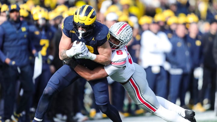 Nov 25, 2023; Ann Arbor, MI, USA;  Michigan tight end Colston Loveland runs against Ohio State safety Sonny Styles during the first half at Michigan Stadium in Ann Arbor on Saturday, Nov. 25, 2023. Mandatory Credit: Junfu Han-USA TODAY Sports