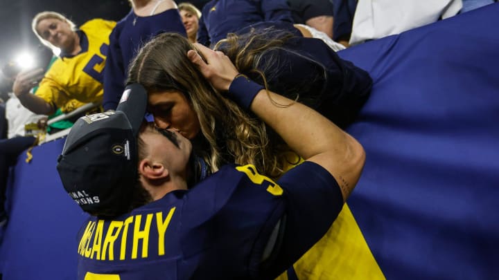 Michigan quarterback J.J. McCarthy kisses his girlfriend Katya Kuropas to celebrate the Wolverines' 34-13 win over Washington to win the national championship at NRG Stadium in Houston on Monday, Jan. 8, 2024.