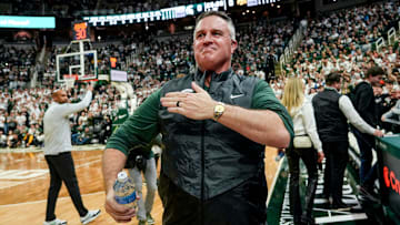 Michigan State's new football coach Pat Fitzgerald pats his heart at the crowd in attendance for the Spartans basketball game against Iowa on Tuesday, Dec. 2, 2025, at the Breslin Center in East Lansing.