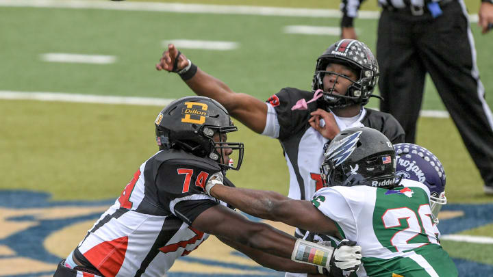 South Carolina defensive back Tyler Jones of Dutch Fork High, SC offensive MVP, passes near the blocking by South Carolina offensive lineman Josiah Thompson of Dillon High, USC Gamecocks commit, and North Carolina defensive lineman Mason Brooks of Salisbury High during the second quarter of the Shrine Bowl of the Carolinas football game at Viking Stadium in Spartanburg, S.C. Saturday, December 16, 2023.