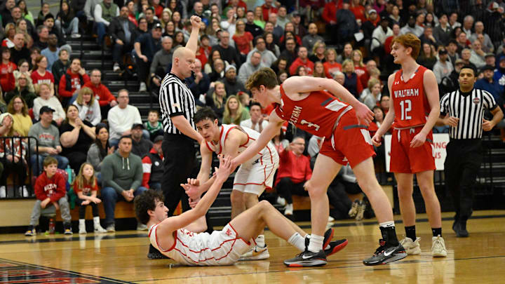 Niko Catalano of North Andover receives help getting up from the ground from teammate Zach Faro and Will Hunt of Waltham during the MIAA Division 1 state tournment basketball game at North Andover High School on Saturday, March 11, 2023. North Andover defeated Waltham 47-46.

11453198002p Ma Nan Boysbasketball8ds