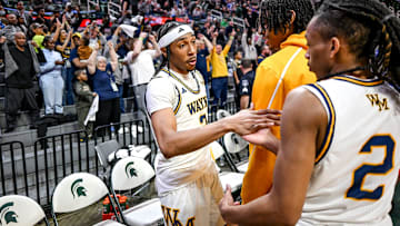 Wayne Memorial's Carlos Medlock Jr., left, shakes hands with Jalahn McClellan after beating Flint Carman-Ainsworth in the Division 1 state semifinal on Friday, March 14, 2025, at the Breslin Center in East Lansing.