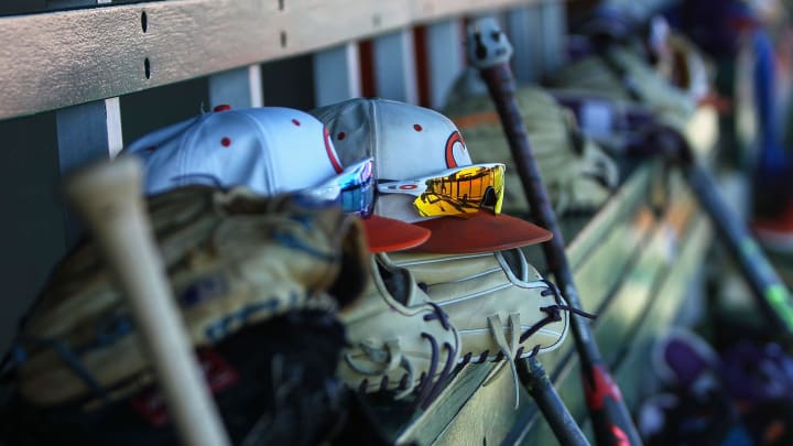 Clemson hats and gloves line the dugout before practice at Doug Kingsmore Stadium in Clemson Friday.