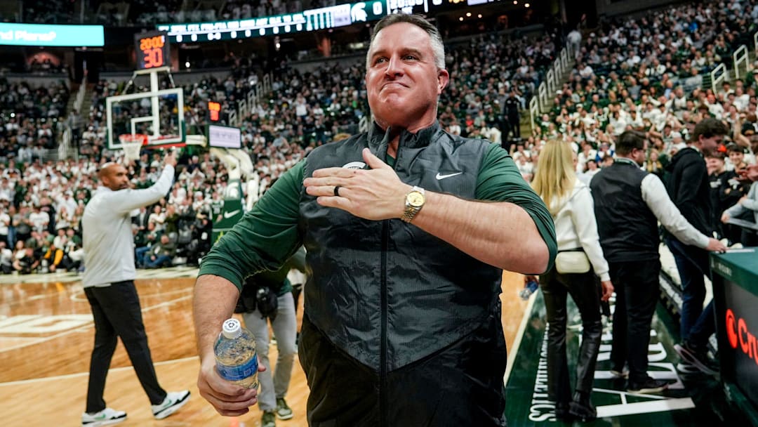 Michigan State's new football coach Pat Fitzgerald pats his heart at the crowd in attendance for the Spartans basketball game against Iowa on Tuesday, Dec. 2, 2025, at the Breslin Center in East Lansing.