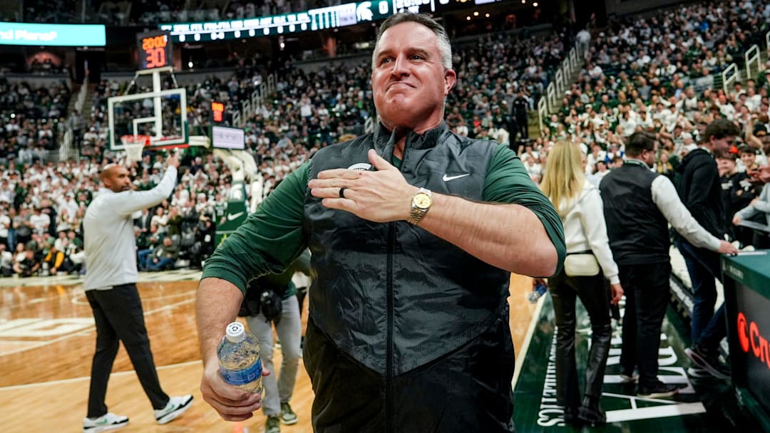 Michigan State's new football coach Pat Fitzgerald pats his heart at the crowd in attendance for the Spartans basketball game against Iowa on Tuesday, Dec. 2, 2025, at the Breslin Center in East Lansing.