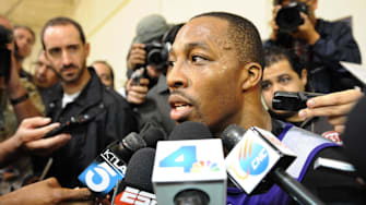 November 15, 2012; El Segundo, CA, USA;    Los Angeles Lakers center Dwight Howard (12) talks to the media before the press conference to introduce new head coach Mike D'Antoni (not pictured) in El Segundo.  Mandatory Credit: Jayne Kamin-Oncea-Imagn Images