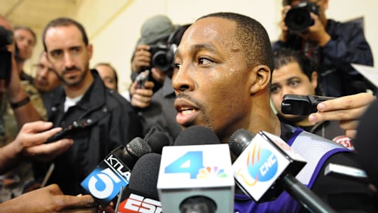 November 15, 2012; El Segundo, CA, USA;    Los Angeles Lakers center Dwight Howard (12) talks to the media before the press conference to introduce new head coach Mike D'Antoni (not pictured) in El Segundo.  Mandatory Credit: Jayne Kamin-Oncea-Imagn Images