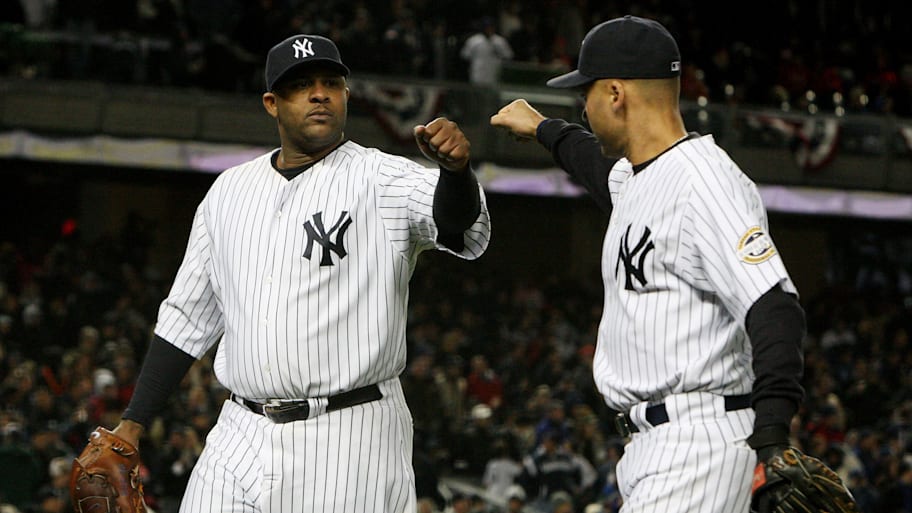 CC Sabathia, left, congratulated by Derek Jeter walking off the field during 2009 ALCS