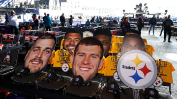 Oversized pictures of Pittsburgh Steelers players sit in the seats