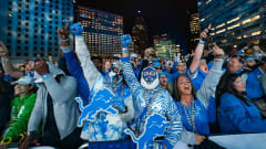 Detroit Lions fans Christopher Guiao, 47, of Sterling Heights, left in mask, and Reiner Calderero.