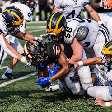 Belleville WR Adrian Walker Jr. is gang tackled by Clarkston during the 2024 Xenith Prep Kickoff Classic at Wayne State's Tom Adams Field in Detroit on Friday, Aug. 30, 2024.