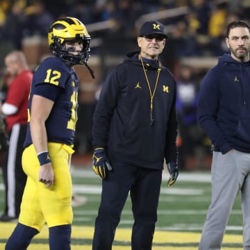 Michigan Wolverines head coach Jim Harbaugh, center, quarterbacks coach Matt Weiss, right, and quarterback Cade McNamara during warmups before action against the Indiana Hoosiers, Saturday, Nov. 6, 2021 at Michigan Stadium.