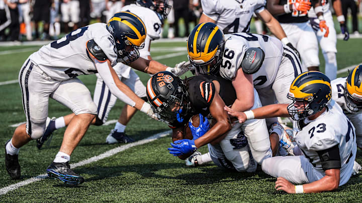 Belleville WR Adrian Walker Jr. is gang tackled by Clarkston during the 2024 Xenith Prep Kickoff Classic at Wayne State's Tom Adams Field in Detroit on Friday, Aug. 30, 2024.