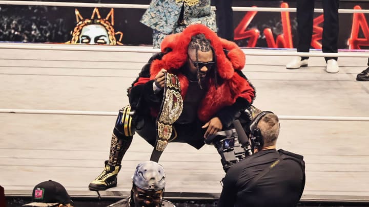 Swerve Strickland poses on the ring apron with the AEW World Championship at Forbidden Door 2024.