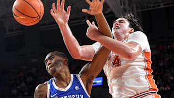 Dec 3, 2024; Clemson, South Carolina, USA; Kentucky forward Brandon Garrison (10) and Clemson senior forward Ian Schieffelin (4) reach for a loose ball during the first half at Littlejohn Coliseum. Mandatory Credit: Ken Ruinard-Imagn Images