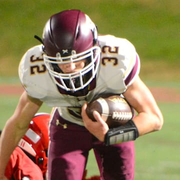 Hayden Allard looks for some running room against New Canaan during the Class L quarterfinals Tuesday at Dunning Field.