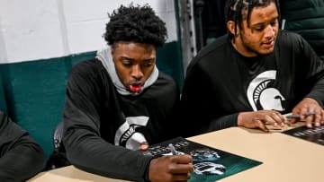 Michigan State quarterback Aidan Chiles signs autographs during the Spring Showcase on Saturday,