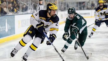 Michigan left wing Rutger McGroarty looks to pass against Michigan State defenseman Maxim Strbak during the third period at Yost Ice Arena in Ann Arbor on Friday, Feb. 9, 2024.