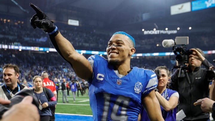 Amon-Ra St. Brown celebrates the Lions' 31-23 win over the Tampa Bay Buccaneers in the NFC divisional round at Ford Field.