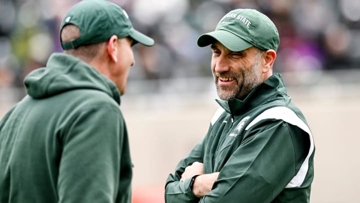 Michigan State defensive coordinator Joe Rossi, right, talks with offensive coordinator Brian Lindgren during the Spring Showcase on Saturday, April 20, 2024, at Spartan Stadium in East Lansing.