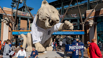Fans get their photo taken next to a giant Tiger statue outside Comerica Park before the Detroit Tigers vs. Cleveland Guardians playoff game in Detroit on Thursday, Oct. 10, 2024.
