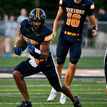 Haslett's Kory Amachree runs for a gain against DeWitt during the second quarter on Thursday, Aug. 29, 2024, at Haslett High School.