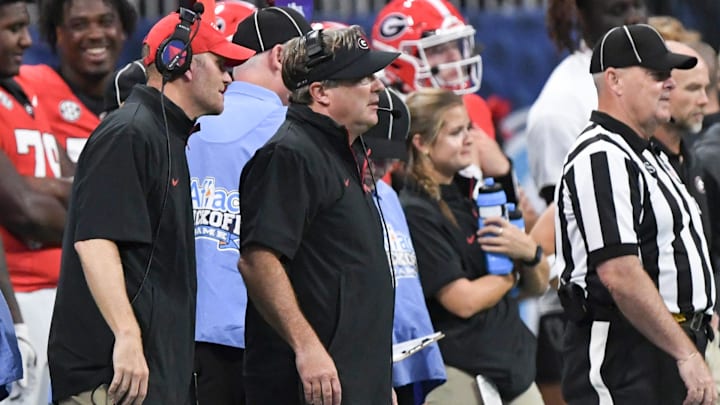 Aug 31, 2024; Atlanta, Georgia, USA; Georgia Bulldogs head coach Kirby Smart looks toward the field as Brandon Streeter stands behind him during the fourth quarter of the 2024 Aflac Kickoff Game against the Clemson Tigers at Mercedes-Benz Stadium. Mandatory Credit: Ken Ruinard-Imagn Images