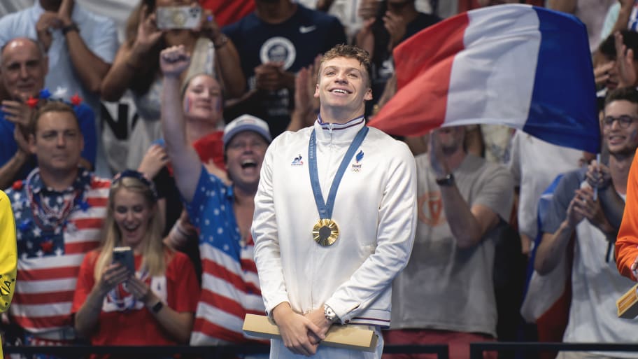 Leon Marchand receiving a gold medal.