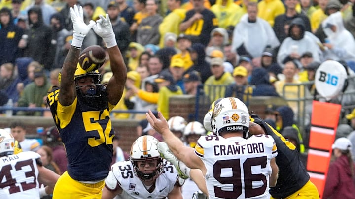 Michigan defensive end Kechaun Bennett blocks the punt of Minnesota punter Mark Crawford during first-half action between Michigan and Minnesota at Michigan Stadium in Ann Arbor on Saturday, Sept. 28, 2024.