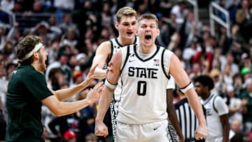 Michigan State's Jaxon Kohler, right, celebrates with teammates Carson Cooper, center, and Gehrig Normand, left, after a MSU score and Nebraska timeout during the second half on Saturday, Dec. 7, 2024, at the Breslin Center in East Lansing.