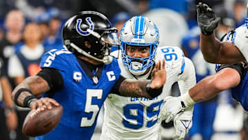 Detroit Lions defensive end Za'Darius Smith pressures Indianapolis Colts quarterback Anthony Richardson during an NFL game