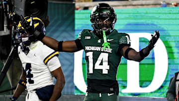 Michigan State's Malcolm Bell, right, reacts after getting called for pass interference against Michigan's Andrew Marsh during the first quarter on Saturday, Oct. 25, 2025, at Spartan Stadium in East Lansing.