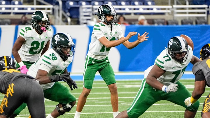 Detroit Cass Tech freshman quarterback Donald Tabron II calls for a snap against Detroit King during the first half of PSL championship at Ford Field in Detroit on Friday, Oct. 18, 2024. Offensive linemen Joshua Paramore (77) and Evan Gooden (58) prepare to block.