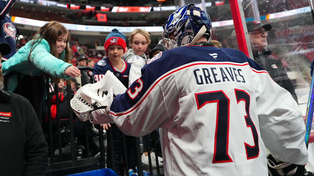 Blue Jackets goalie Jet Greaves gives a fan a puck after warmups