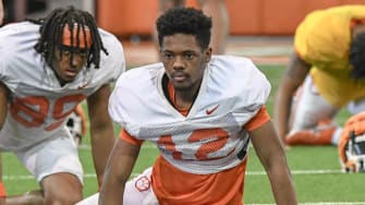 Clemson wide receiver Bryant Wesco Jr. (12) stretches during Spring football practice at the Poe Indoor Practice Facility at the Allen N. Reeves football complex in Clemson S.C. Monday, March 4, 2024.