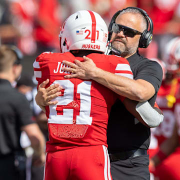 Nebraska coach Matt Rhule and running back Emmett Johnson embrace before a game against Houston Christian.