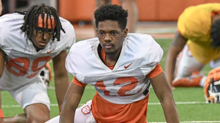 Clemson wide receiver Bryant Wesco Jr. (12) stretches during Spring football practice at the Poe Indoor Practice Facility at the Allen N. Reeves football complex in Clemson S.C. Monday, March 4, 2024.