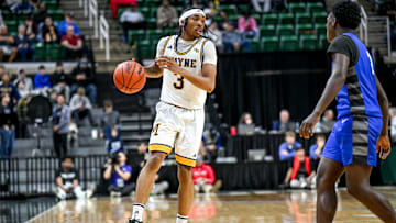 Wayne Memorial's Carlos Medlock Jr. moves the ball against Flint Carman-Ainsworth during the second quarter in the Division 1 state semifinal on Friday, March 14, 2025, at the Breslin Center in East Lansing.