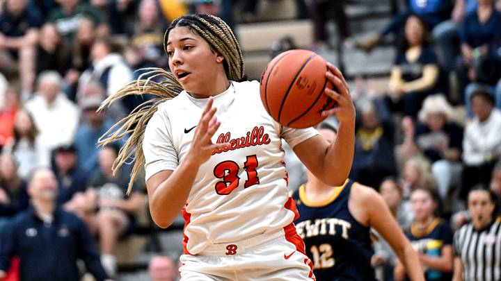 Belleville's Sydney Savoury grabs a rebound against DeWitt during the third quarter on Tuesday, March 18, 2025, in the D1 state quarterfinal at Holt High School.