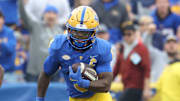 Nov 15, 2025; Pittsburgh, Pennsylvania, USA;  Pittsburgh Panthers running back Desmond Reid (0) runs after catch against the Notre Dame Fighting Irish during the first quarter at Acrisure Stadium. Mandatory Credit: Charles LeClaire-Imagn Images