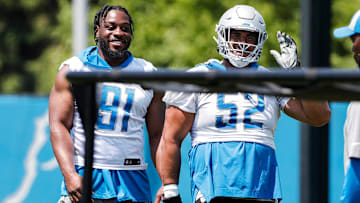 Detroit Lions defensive end Levi Onwuzurike (91) talks to defensive lineman Christian Covington (52) during OTAs at Detroit Lions headquarters in Allen Park on Thursday, June 1, 2023.