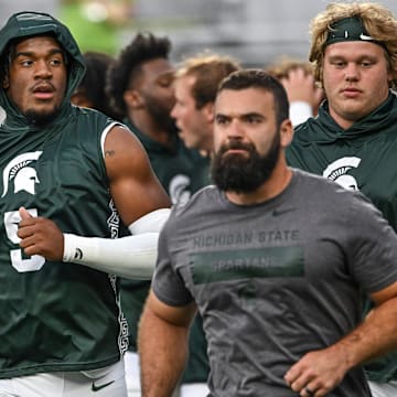 Michigan State's Jordan Hall, center, and the rest of the Spartans head back to the locker room before the game against Florida Atlantic on Friday, Aug. 30, 2024, at Spartan Stadium in East Lansing.