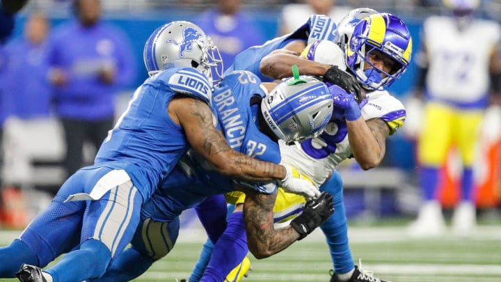 L.A. Rams running back Kyren Williams (23) is tackled by Detroit Lions safety Brian Branch (32) during the second half of the NFL wild-card playoff game at Ford Field in Detroit on Sunday, Jan, 14, 2024.