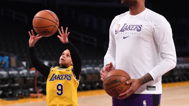 Jan 1, 2020; Los Angeles, California, USA;  Pierre Rondo, son of Los Angeles Lakers guard Rajon Rondo (9), has a shooting contest with center DeMarcus Cousins (15) on the court before the game against the Phoenix Suns at Staples Center. Mandatory Credit: Jayne Kamin-Oncea-USA TODAY Sports