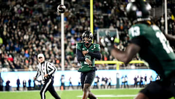 Michigan State's Aidan Chiles, left, throws the ball to Ademola Faleye during the second quarter in the game against Purdue on Friday, Nov. 22, 2024, at Spartan Stadium in East Lansing.