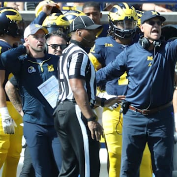 Connor Stalions, left, stands next to Michigan coach Jim Harbaugh during the team's game against Rutgers, Sept. 23, 2023 at Michigan Stadium in Ann Arbor.