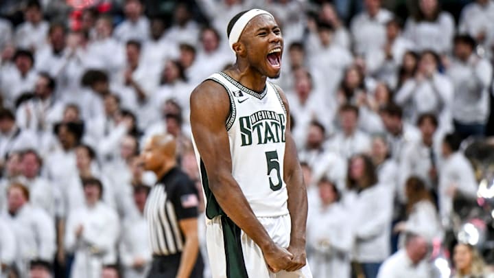 Michigan State's Tre Holloman, left, celebrates after making a 3-pointer against Oregon during the second half on Saturday, Feb. 8, 2025, at the Breslin Center East Lansing.