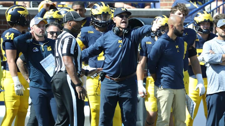 Connor Stalions, left, stands next to Michigan coach Jim Harbaugh during the team's game against Rutgers, Sept. 23, 2023 at Michigan Stadium in Ann Arbor.