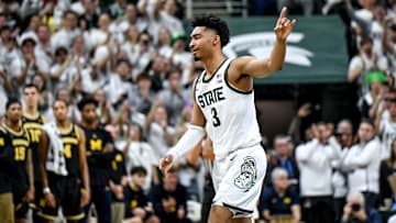 Michigan State's Jaden Akins acknowledges the fans after kissing the Spartans logo before getting subbed out late during the second half in the game against Michigan 